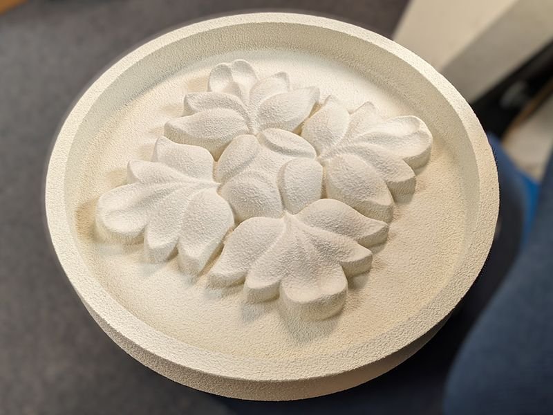 1 Cementicious coating on a round medallion