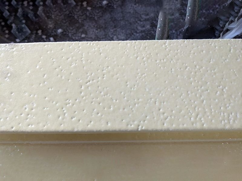 5 Close-up of a urethane and polyuria hard coat finish showing the orange peel effect of the coating