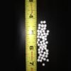 Expanded polystyrene beads next to a measuring tape