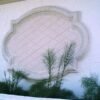 Geometric Medallion with frame and crisscross lines from Architectural Foam on a house