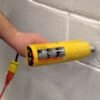 Heat gun is melting Styrofoam expanded polystyrene EPS foam to make it look like stone blocks