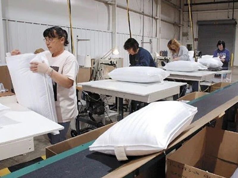 Manufacturing pillows filled with shredded foam in a factory