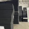 Sheets of cross-linked XLPE foam sheets in charcoal gray and black colors in a wholesale warehouse