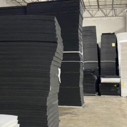 Sheets of cross-linked XLPE foam sheets in charcoal gray and black colors in a wholesale warehouse