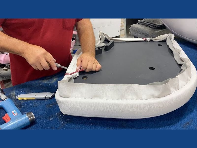 Worker manufacturing boat seat cushion